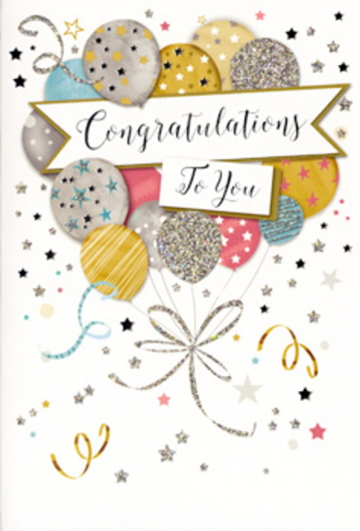 The photograph captures a tall congratulations card in a vertical format, the kind you might choose to send alongside a thoughtfully arranged bouquet delivered across New Eltham. The card front is dominated by a harmonious arrangement of illustrated balloons that rise from the midsection toward the top edge, overlapping to create a sense of depth and buoyancy. Their tones are delicately balanced: soft metallic gold and silver, champagne beige, cool sky blue, rosy blush pink and gentle dove grey. Each balloon is finished with intricate decorative details-tiny starbursts, fine glittering dots, slim bands and curls-that glint as though the card were catching sunlight near a bay window looking out onto Avery Hill. From the base of this balloon bouquet, slender metallic ribbons unfurl in sweeping curves toward the lower margin, drawn in shimmering gold and silver that suggests the gleam of satin when it catches the light. These ribbons introduce movement, echoing the trailing stems and greenery that add grace to a florist's hand-tied arrangement. Across the centre of the balloons stretches a softly arched banner, its pale surface framed by a thin metallic border. The message "Congratulations To You" appears in flowing, calligraphic script that feels poised yet heartfelt, perfectly suited to life's proud transitions-whether exam successes, job promotions or special anniversaries in the New Eltham community. The background colour is a quiet, creamy neutral, peppered with delicately drawn metallic stars, confetti specks and curling streamers. This subtle scattering creates a festive, confetti-like atmosphere without overwhelming the main design. The card's finish appears smooth and slightly glossy, with certain areas-particularly the stars and balloon patterns-possessing a raised or foil-like sheen that invites touch. It is a visually rich yet understated image of celebration, effortlessly evoking joy, admiration and the sense that an important moment is being honoured.